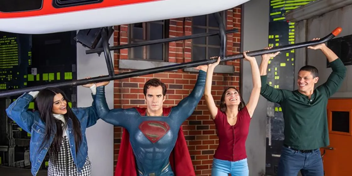 Tourists interacting with Superman wax figure at Madame Tussauds.